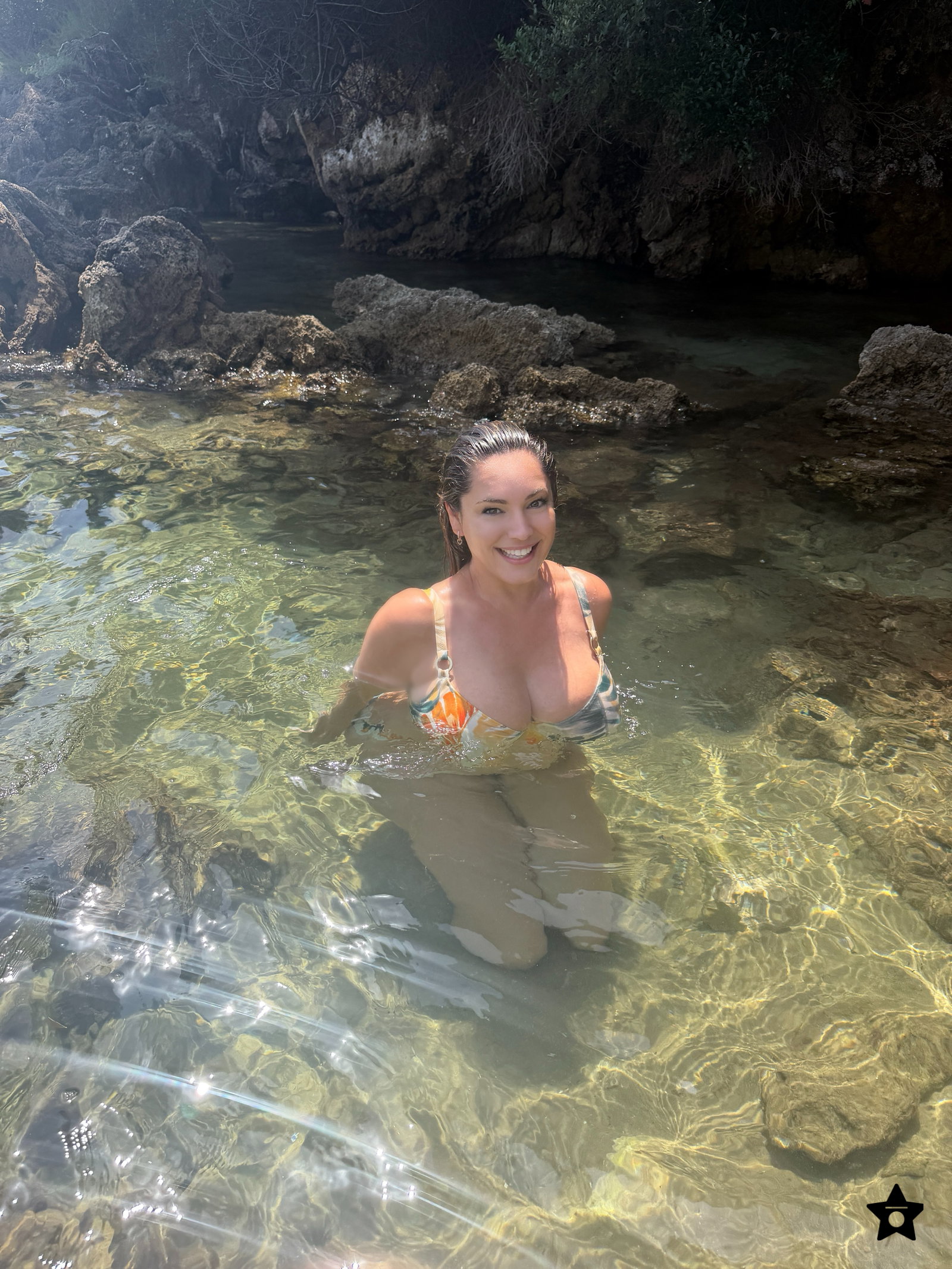 Kelly Brook shows off her incredible curves in a floral bikini