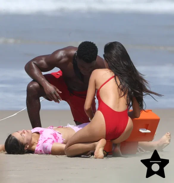 shay-mitchell-films-baywatch-in-a-red-swimsuit-july-2026-4 Shay Mitchell Films Baywatch in a Red Swimsuit July 2026